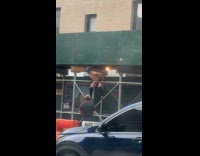 Shirtless man batman mask hang on scaffolding