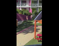 Girl bikini pose beside purple ledge yard