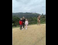 Woman in lingerie pose beside family Hollywood. 