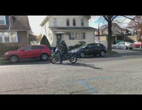 Guy leaves on motorbike by doing a wheelie 