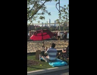 Guy plays air drums beach volleyball net 