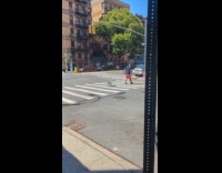 Man dragging air condition unit on street
