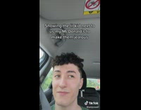 Guy green shirt lifts mcdonalds paper bag in car