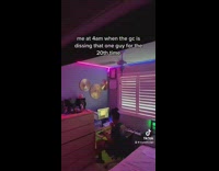 Guy sitting at desk laughing LED pink light room