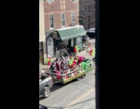 Mascots and Santa on trailer pulled by truck