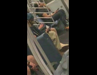 Man lights an incense stick and cleans his ears on subway train