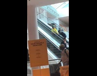 girl yellow sweater sits escalator
