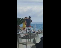 Couple kiss yellow dress  arm tattoos cameraman