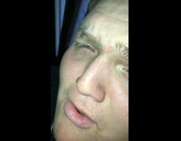 Guy sings high pitched Your Man song, close up to face