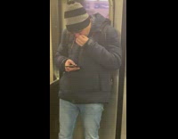 Guy on phone picks nose on subway train