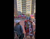 Woman hugs friends chugs drink during marathon