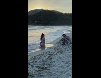 Girl blue bikini kneel beach striped towel