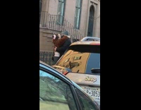 Couple on the sidewalk making out and kissing with their masks on 
