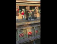 Guy green jacket dances at train station