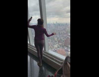 Woman takes selfie at World Trade Center window