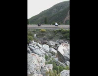 Black pants girl lays back road mountain 