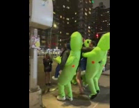 Collab WINY - Men in Inflatable Alien Costume Cheers around woman