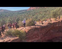 Woman white headband raise hand sedona cliff