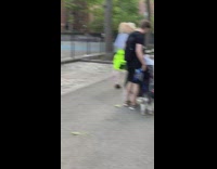 Old man walks with dog around shoulders and people stare 