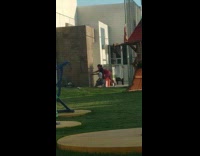 Mom fixes hand white shirt girl squats 