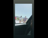 Two teen girls dance tiktok behind car