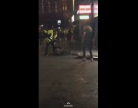 Guy tries to get past security guards and runs into metal gate