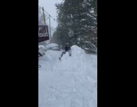 Guy jumps off balcony onto snow pile 
