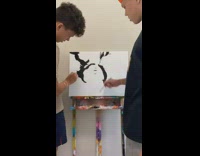 Two guys work on same squid game painting 