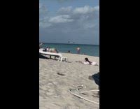 Woman white bikini frills lay hold sand