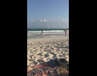 Red shorts beach shore red towel 