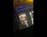 White shirt girl clips toenails inside restaurant 