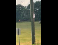 Man plays guitar for video at field