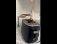 Toaster burning with bread inside