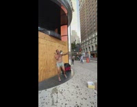 Guy plays trombone instrument outside victorias secret 