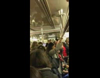 subway crowd sings same song together