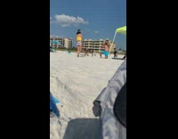 Girl black hat frilly yellow top beach