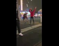 Woman red jacket hands up carnival