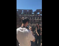 Girl poses in front of colosseum 