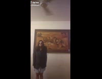 Black sweater sunglasses girl dances ceiling fan