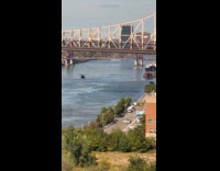 Army helicopter flying underneath queensborough bridge