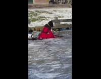 Woman red coat picnic blanket ice rink