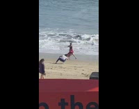 Woman red dress dance video shoot beach