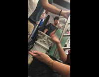 Statue costumer with white pillar talks to guy on subway train