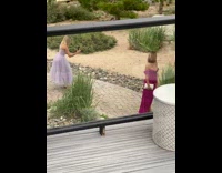 Woman in violet dress poses at the wedding ceremony