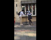 Guy maid costume eat near windows street