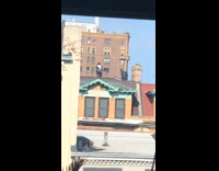 Guy exercises on rooftop bicycle green trim