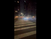 Men shoot fireworks at each other on street