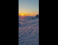 Guy make snowmobile jump on snow ramp
