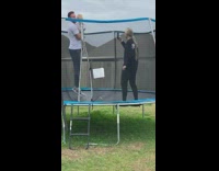 Dad holds baby and bounces on trampoline 