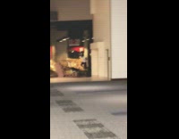 Two guys run into and tackle Hustle movie poster in shopping mall